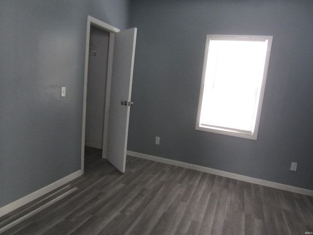 spare room with dark hardwood / wood-style floors