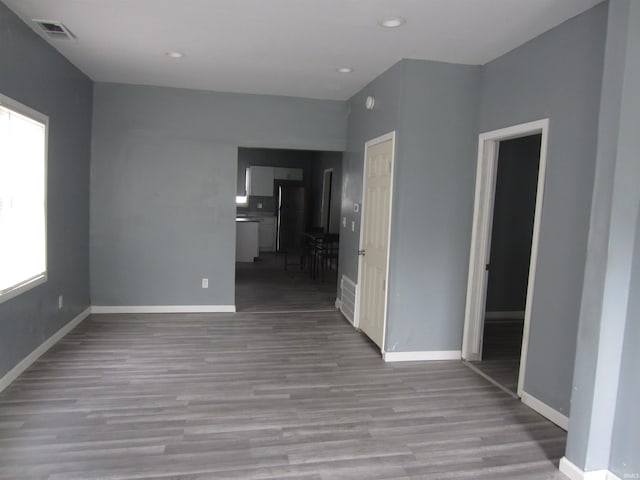 spare room featuring a healthy amount of sunlight and light wood-type flooring