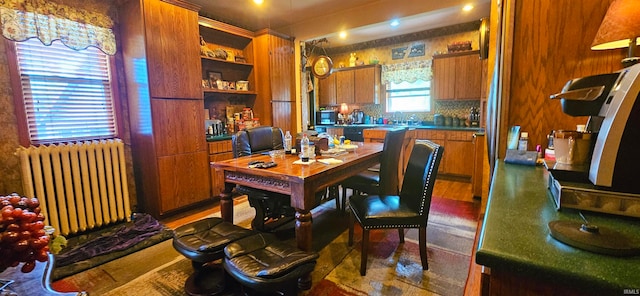 tiled dining room featuring radiator heating unit