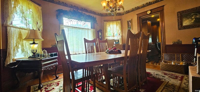 dining room featuring hardwood / wood-style floors and a notable chandelier