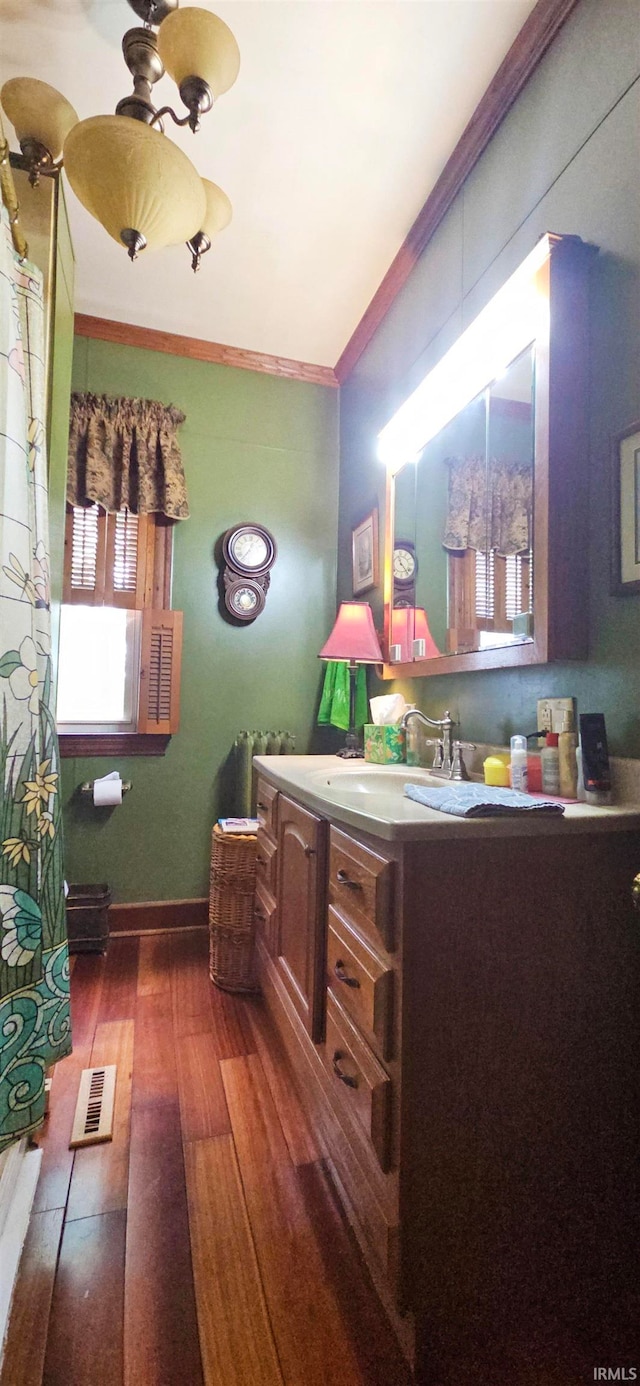 interior space featuring radiator, sink, dark hardwood / wood-style flooring, and crown molding