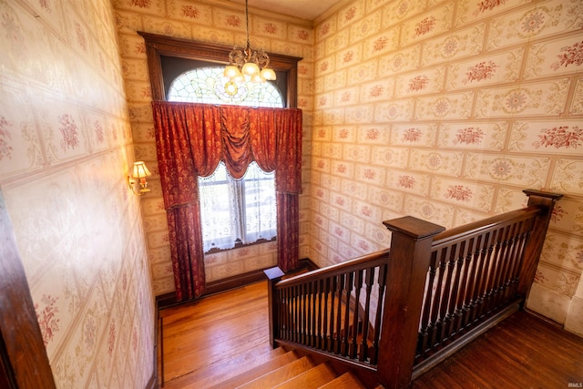 foyer entrance with hardwood / wood-style flooring and a chandelier