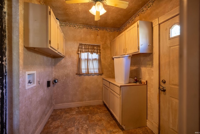 laundry area with ceiling fan, electric dryer hookup, washer hookup, dark tile flooring, and cabinets