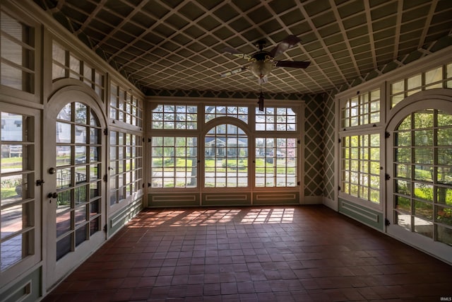 unfurnished sunroom featuring a healthy amount of sunlight and ceiling fan