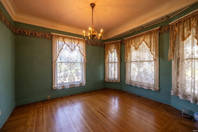 unfurnished room with ornamental molding, hardwood / wood-style flooring, a tray ceiling, and an inviting chandelier