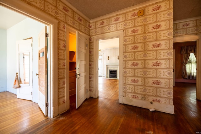 corridor featuring hardwood / wood-style flooring and ornamental molding