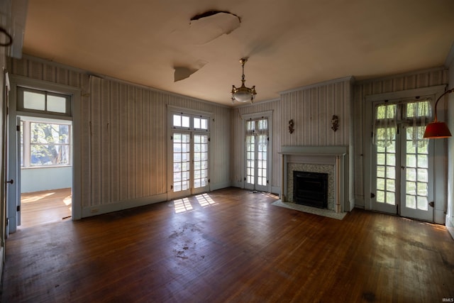 unfurnished living room featuring french doors and dark wood-type flooring