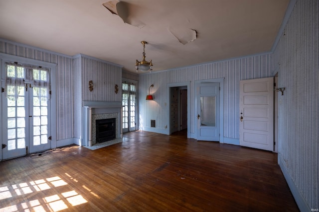 unfurnished living room featuring dark hardwood / wood-style flooring and plenty of natural light