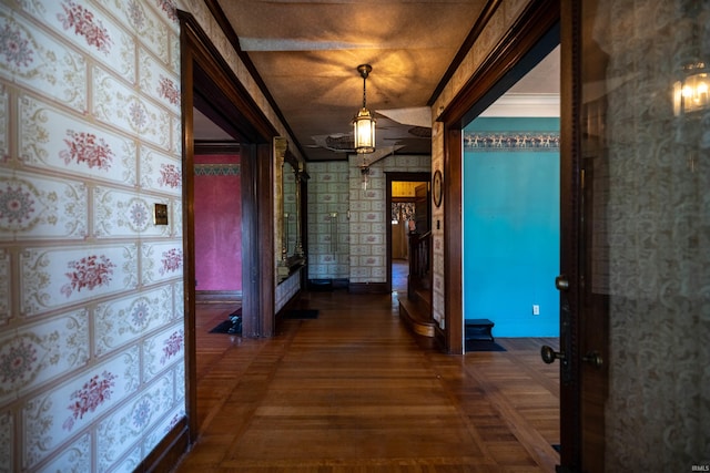 hallway featuring dark hardwood / wood-style flooring and crown molding