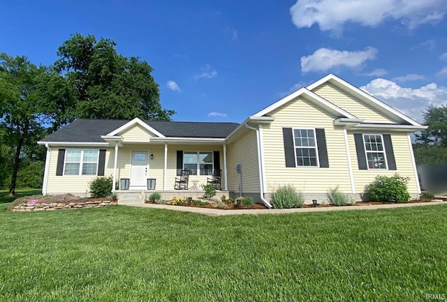 ranch-style house with a front yard and covered porch