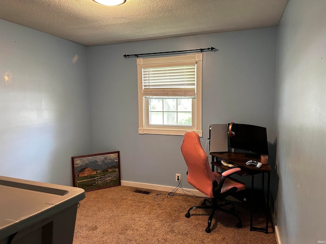 carpeted office space featuring a textured ceiling