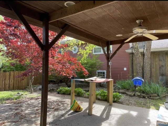 view of patio / terrace with ceiling fan and fence