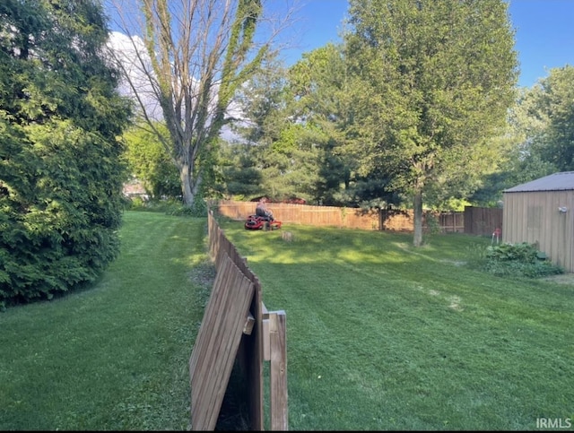 view of yard with an outdoor structure and fence