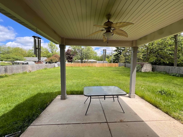 view of patio / terrace featuring ceiling fan and a storage unit