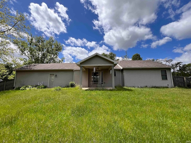 back of house with a lawn