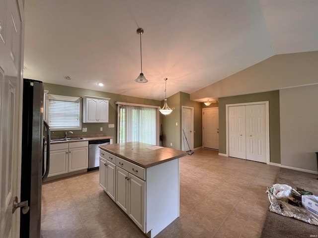 kitchen featuring a kitchen island, white cabinets, sink, stainless steel appliances, and vaulted ceiling