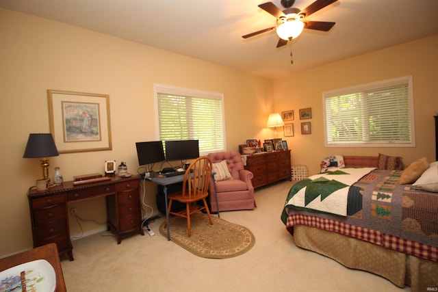 bedroom with ceiling fan and light carpet