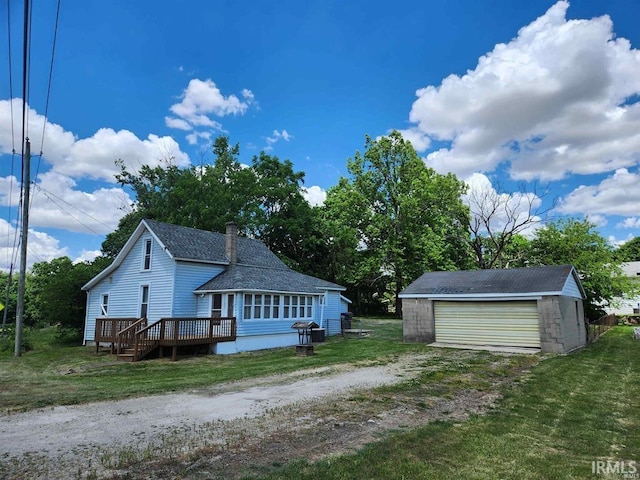 view of property exterior with a garage, a deck, and an outdoor structure