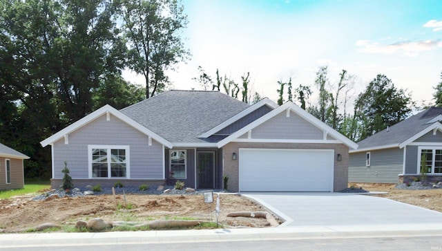 craftsman house featuring concrete driveway, brick siding, a garage, and roof with shingles