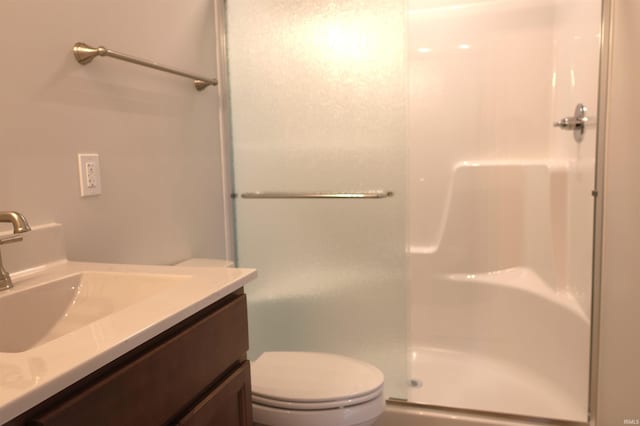 bathroom with vanity, toilet, and walk in shower