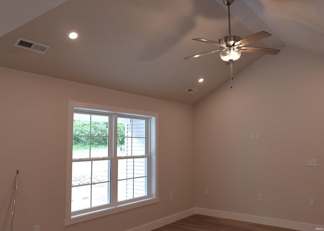 unfurnished room with vaulted ceiling, a ceiling fan, visible vents, and baseboards