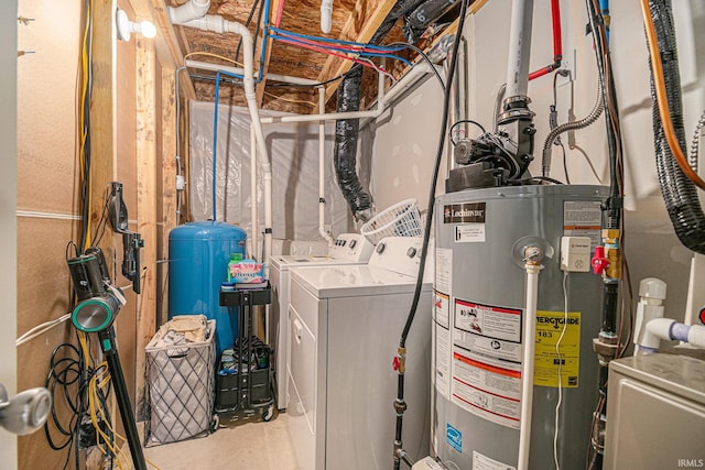 utility room featuring water heater and independent washer and dryer