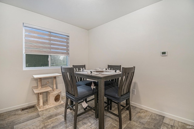 dining room with wood-type flooring