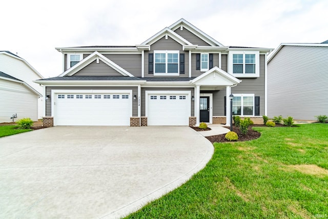 view of front of house featuring a garage and a front lawn