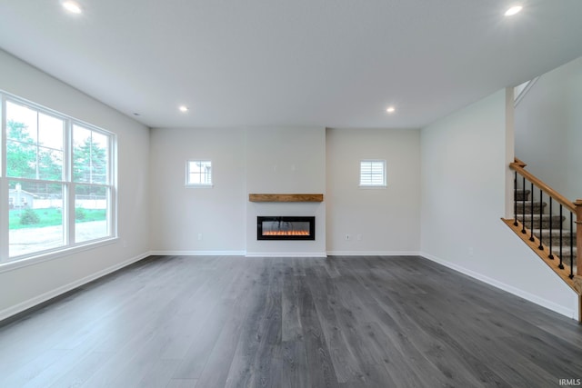 unfurnished living room featuring dark wood-type flooring