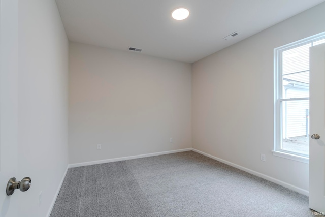 carpeted empty room featuring a healthy amount of sunlight