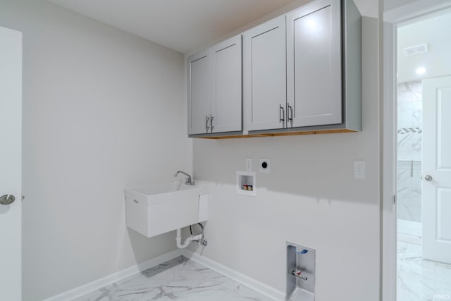 washroom featuring cabinets, hookup for an electric dryer, light tile floors, and washer hookup