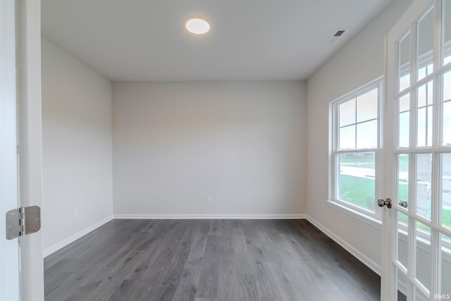 empty room featuring french doors and wood-type flooring