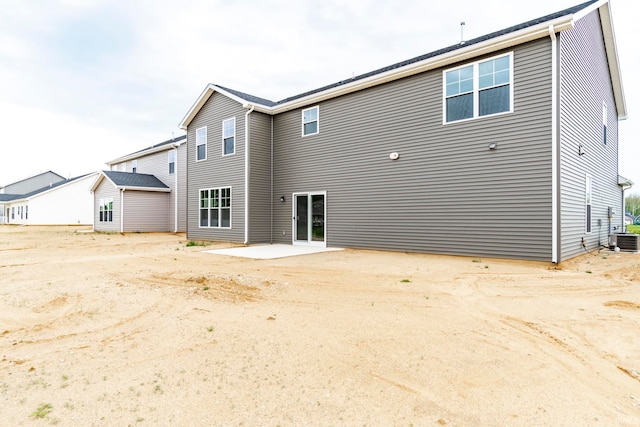 rear view of property with a patio area and central air condition unit