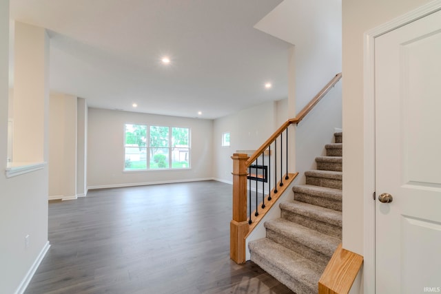 stairway with dark hardwood / wood-style floors