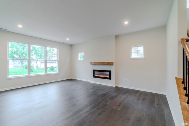 unfurnished living room featuring dark hardwood / wood-style floors