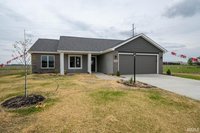 ranch-style house with a garage and a front lawn