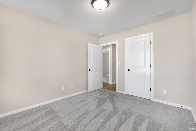 1016 Bryce Cir, Ligonier, IN 46767 - unfurnished bedroom featuring baseboards, visible vents, and carpet