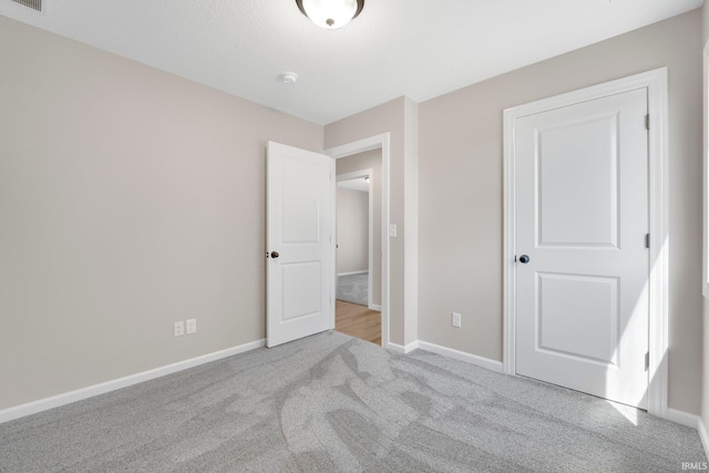 1016 Bryce Cir, Ligonier, IN 46767 - unfurnished bedroom featuring visible vents, baseboards, and carpet flooring