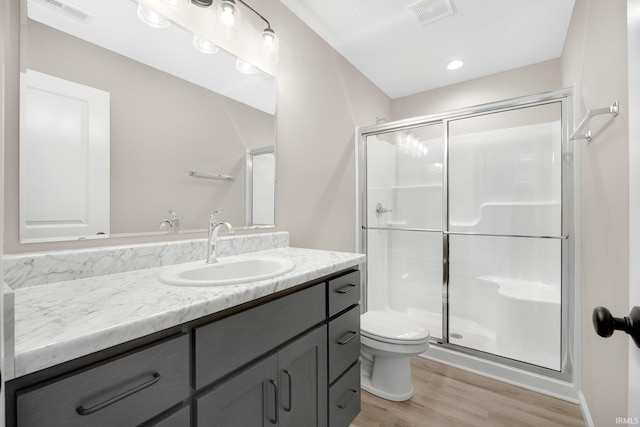 1016 Bryce Cir, Ligonier, IN 46767 - bathroom featuring wood finished floors, visible vents, and a stall shower