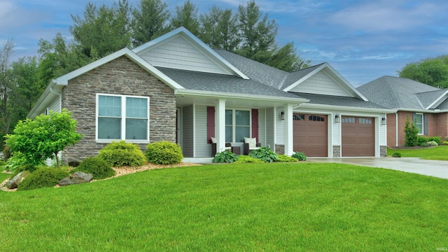 view of front of home with a front yard and a garage