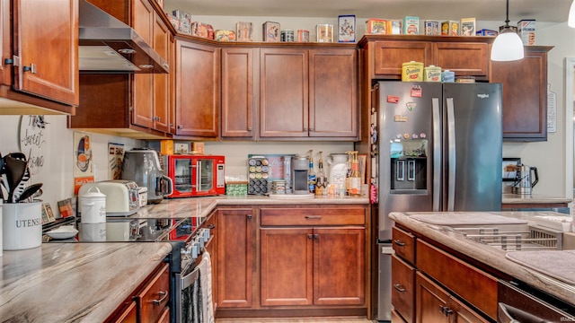 kitchen with wall chimney range hood, stainless steel fridge, decorative light fixtures, and range with electric cooktop