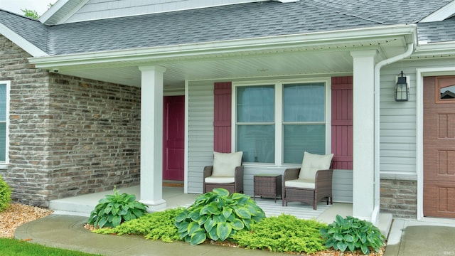 view of exterior entry featuring covered porch