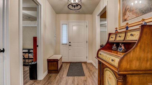 entrance foyer featuring a notable chandelier and hardwood / wood-style floors