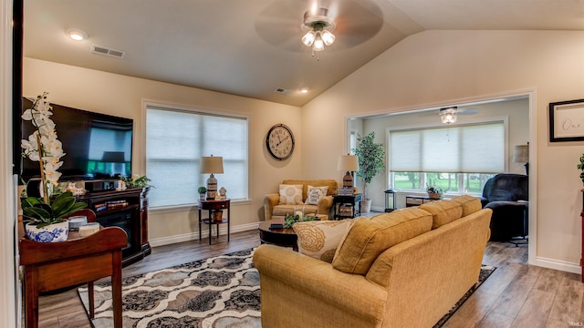 living room with vaulted ceiling, hardwood / wood-style floors, and ceiling fan