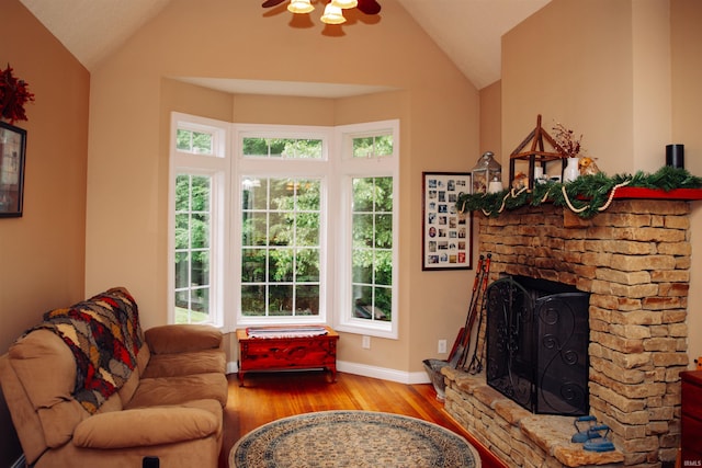 living room featuring vaulted ceiling, hardwood / wood-style floors, and a wealth of natural light