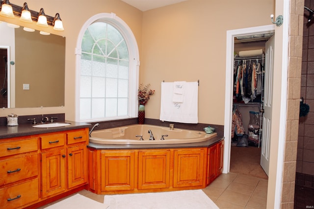 bathroom featuring a washtub, oversized vanity, and tile flooring