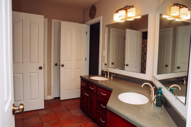 bathroom featuring a notable chandelier, dual bowl vanity, and tile floors