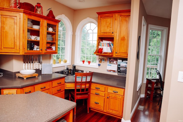 kitchen featuring built in desk and dark wood-type flooring