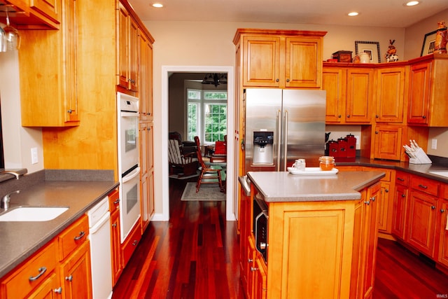 kitchen with dark hardwood / wood-style floors, a kitchen island, high end fridge, and white dishwasher