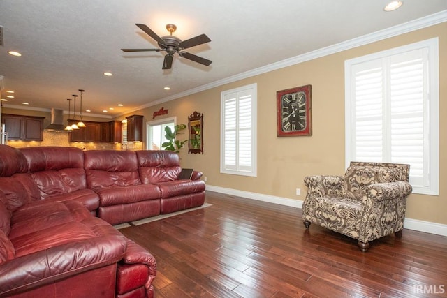 living room featuring ornamental molding, dark wood-type flooring, and ceiling fan